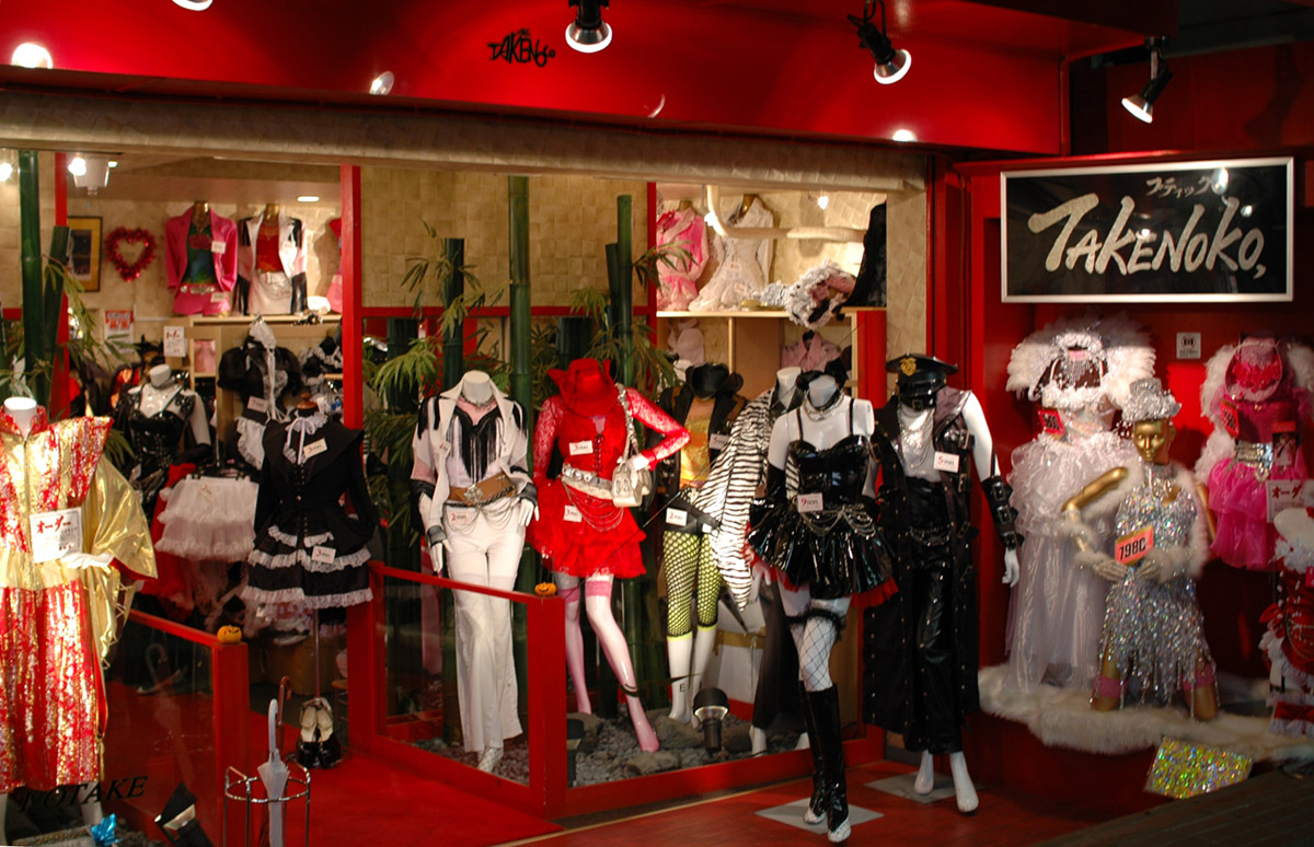Shop window of Boutique Takenoko in Harajuku at night with mannequins in frilled, leather and sequinned outfits