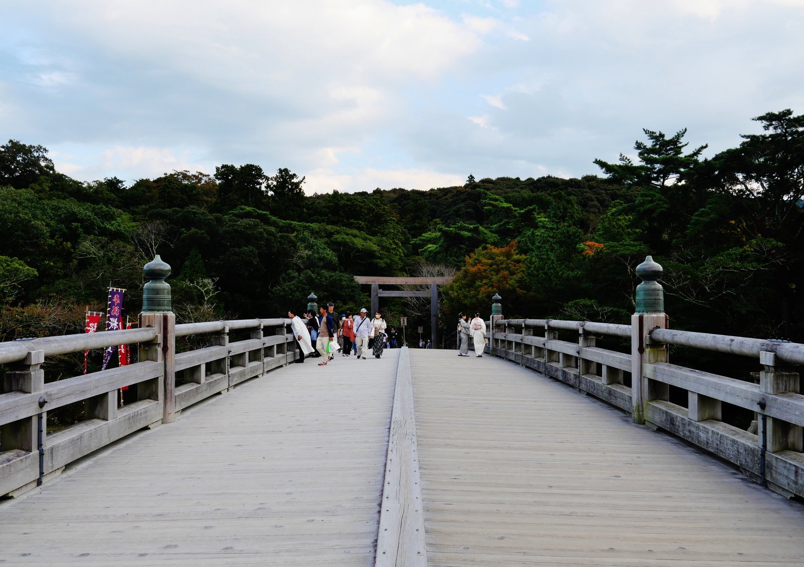 Wooden Uji Bridge leading to the plain torii gate at the entrance of Ise Jingu Naiku