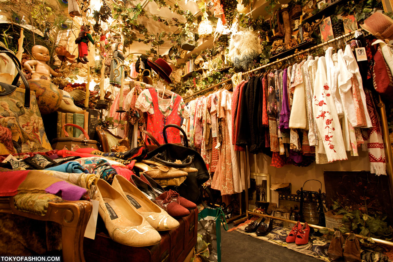 Rack of vintage embroidered blouses, shoes and antiques inside a Tokyo vintage clothing shop