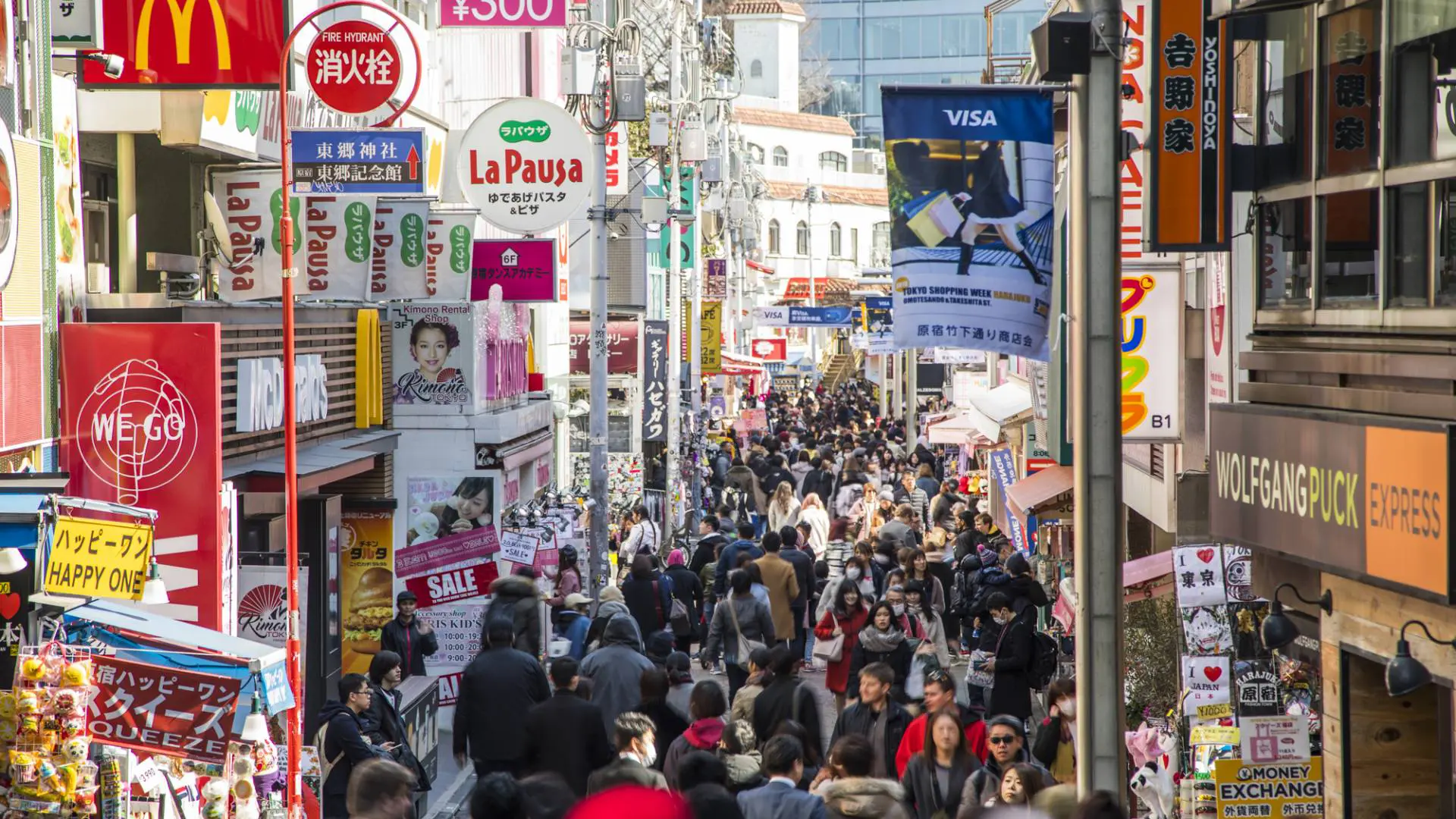 Crowds on Takeshita Street in Harajuku, Tokyo, lined with fashion shops and signage