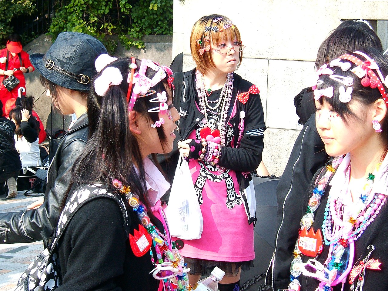 Decora coords in Harajuku with dense hair clips, layered bead necklaces and bright pink over black
