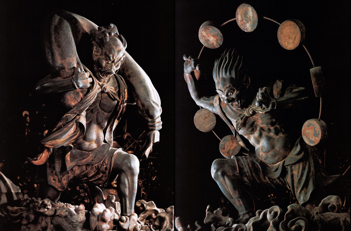 Wooden Fujin and Raijin statues at Sanjusangen-do temple, Fujin gripping the wind bag overhead
