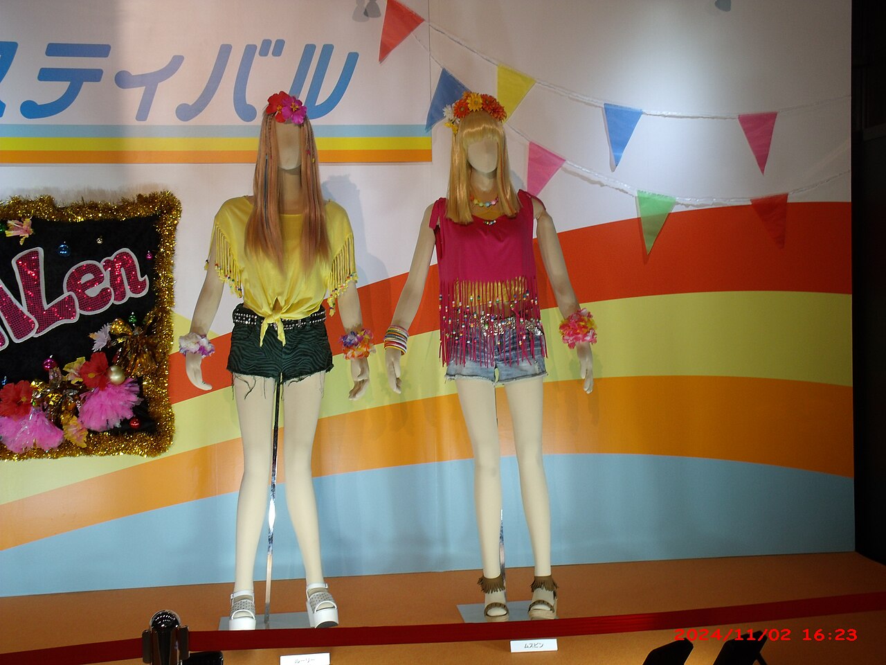 Mannequins in neon fringed tops, denim shorts, flower headpieces and platform sandals