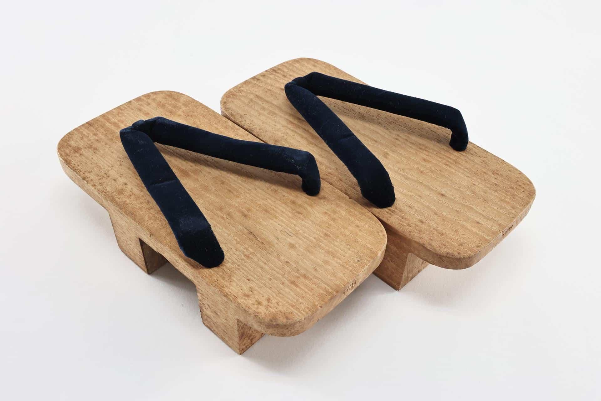 Plain unlacquered wooden geta showing the two supporting teeth underneath the base