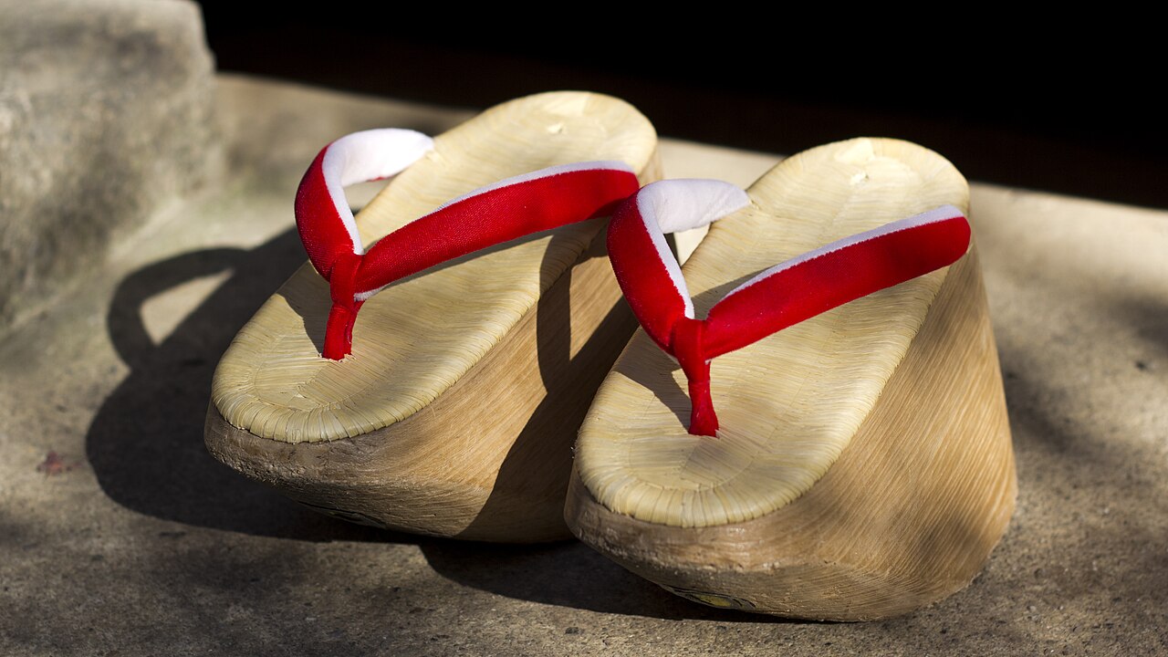 Tall solid wood okobo geta with red and white hanao straps