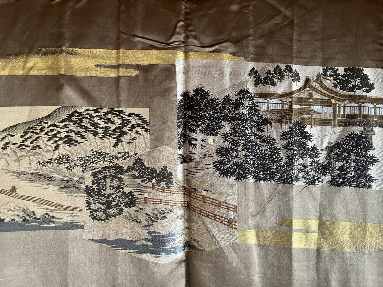 Formal black silk montsuki haori with a family crest, worn for a ceremonial occasion