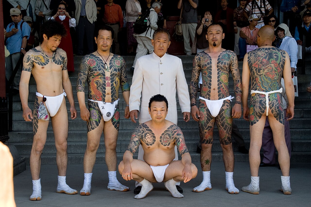 Group of men at a Tokyo festival showing full body irezumi bodysuits with flowers, koi and dragons