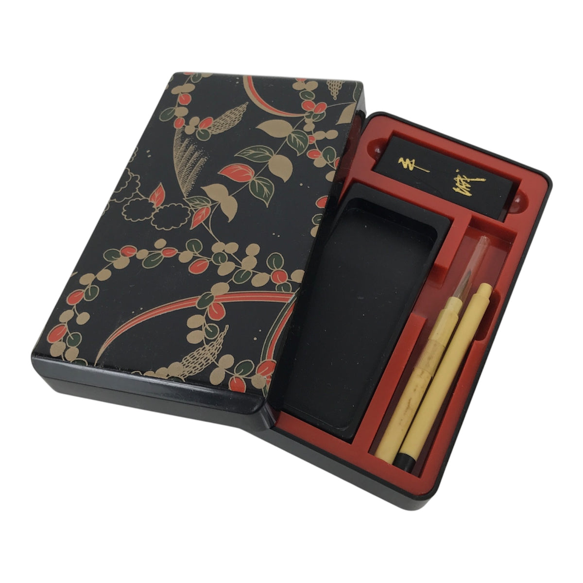 Open lacquered Japanese calligraphy box with two bamboo brushes, an ink stone well and a floral painted lid