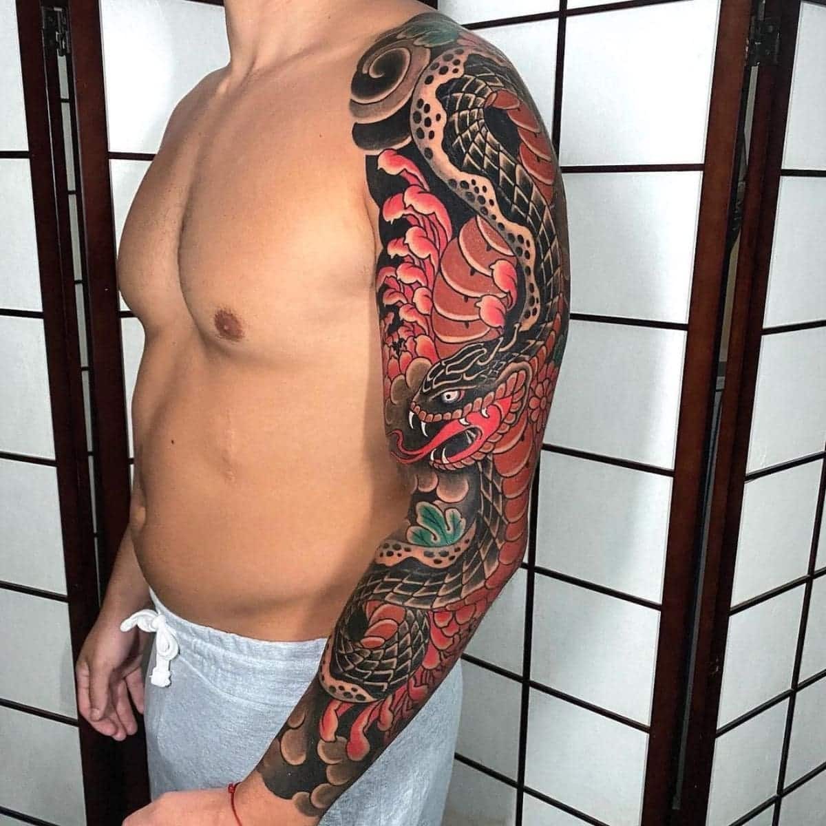 Traditional Japanese snake tattoo sleeve with cherry blossoms