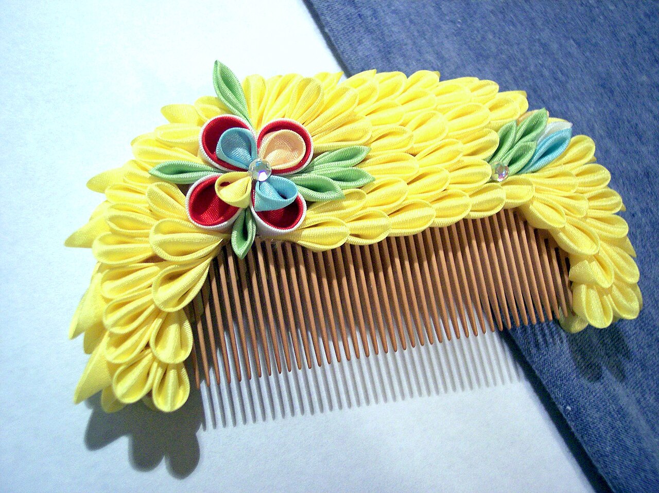 Yellow tsumami kanzashi flower comb made from folded silk petals