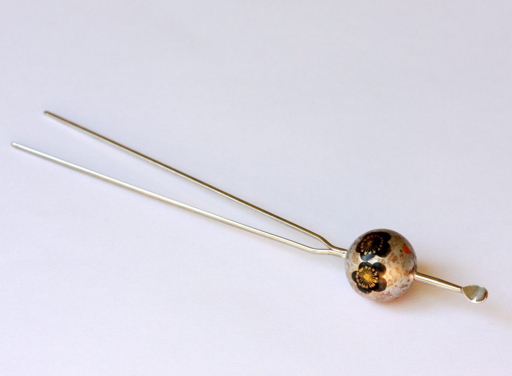 Two-pronged silver kanzashi hairpin topped with a decorated ball