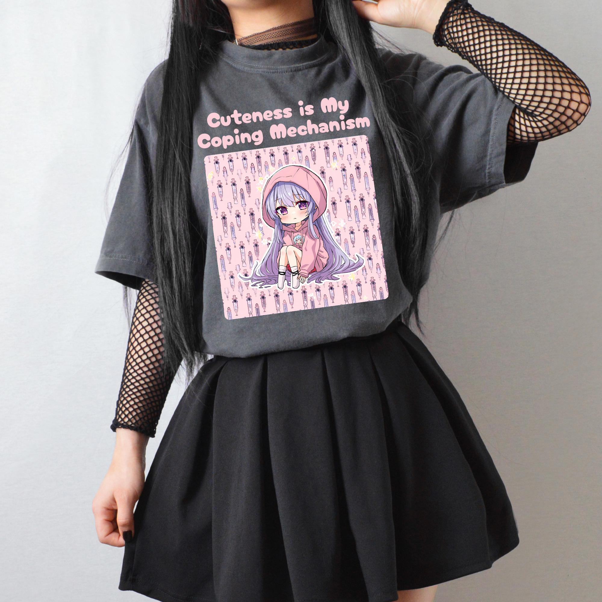 Charcoal oversized tee with a pastel syringe print graphic worn with a black pleated skirt and fishnet sleeves