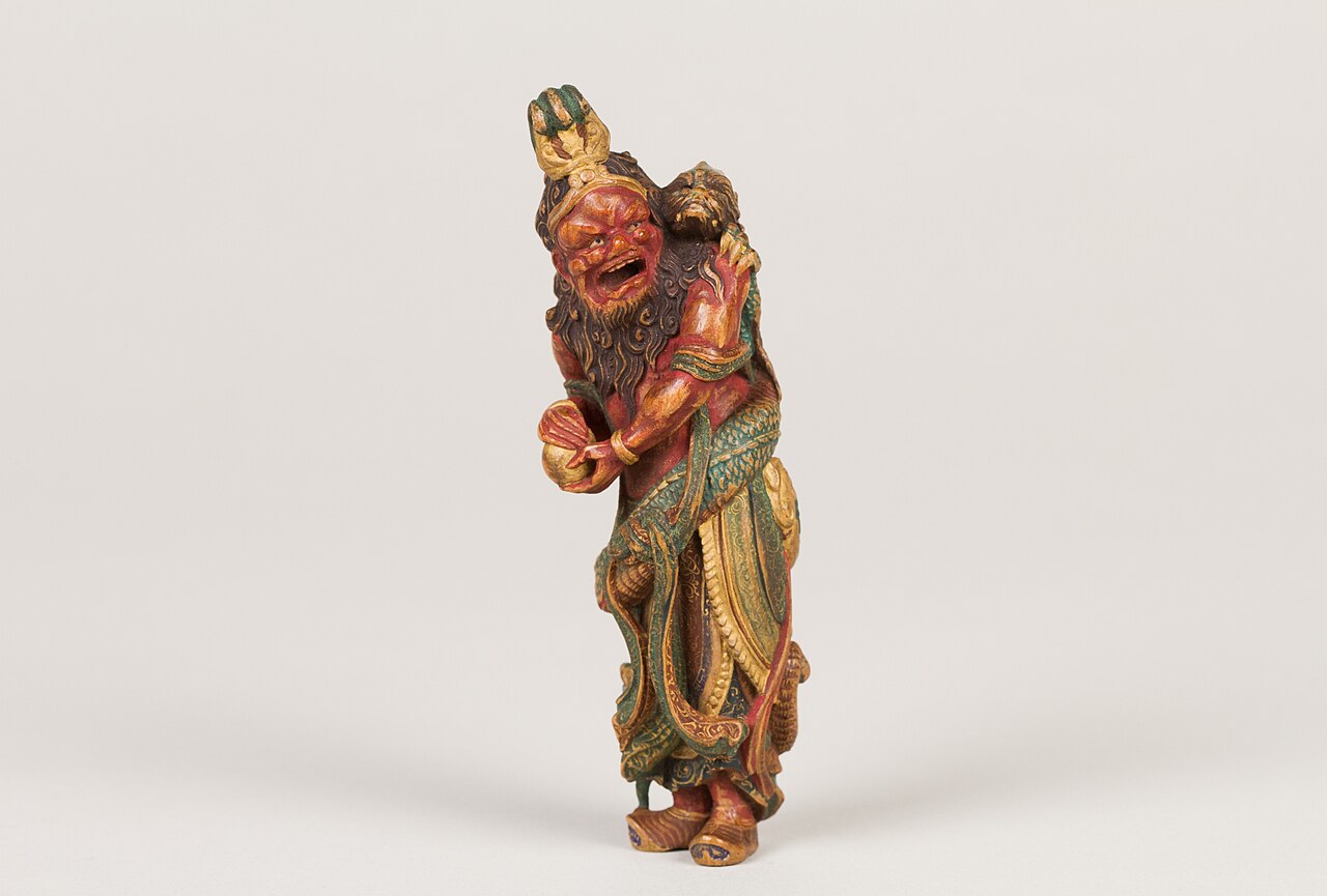 Carved Ryujin figure, the Japanese dragon god of the sea, holding a tide jewel