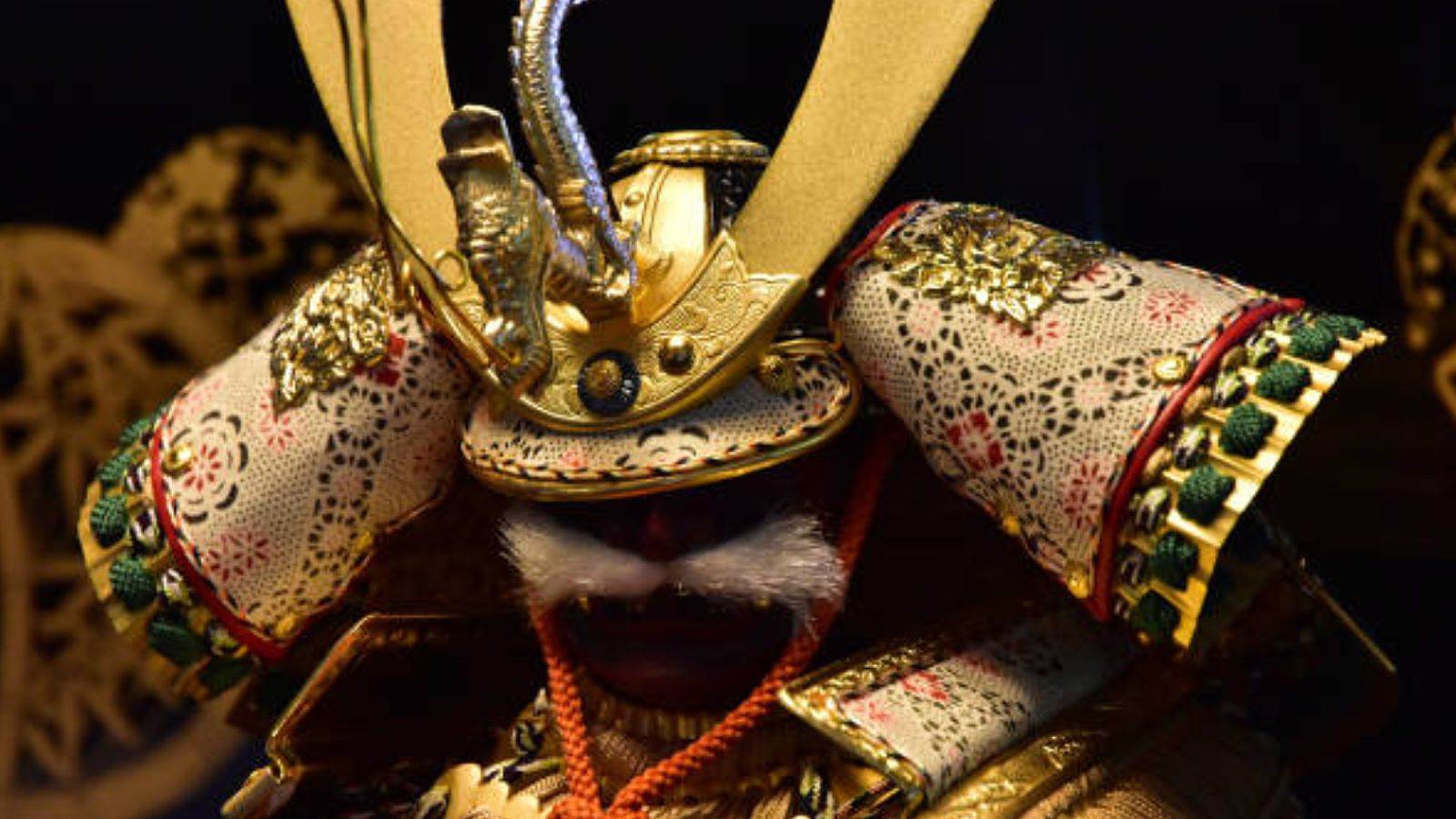 Gilded samurai armor with large sode shoulder guards flanking the helmet