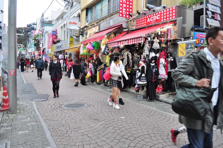 Harajuku street scene on Takeshita Street in Tokyo, with a crowd of shoppers passing storefronts