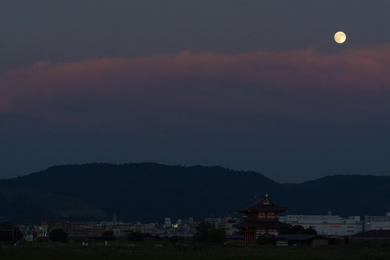 Full moon rising over the reconstructed Suzakumon gate of Heijo Palace in Nara at dusk