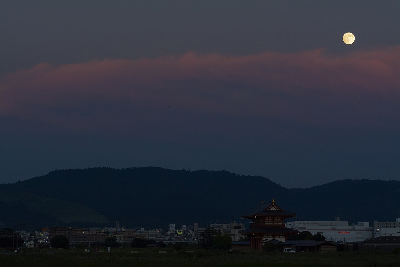 Full moon rising over the reconstructed Suzakumon gate of Heijo Palace in Nara at dusk