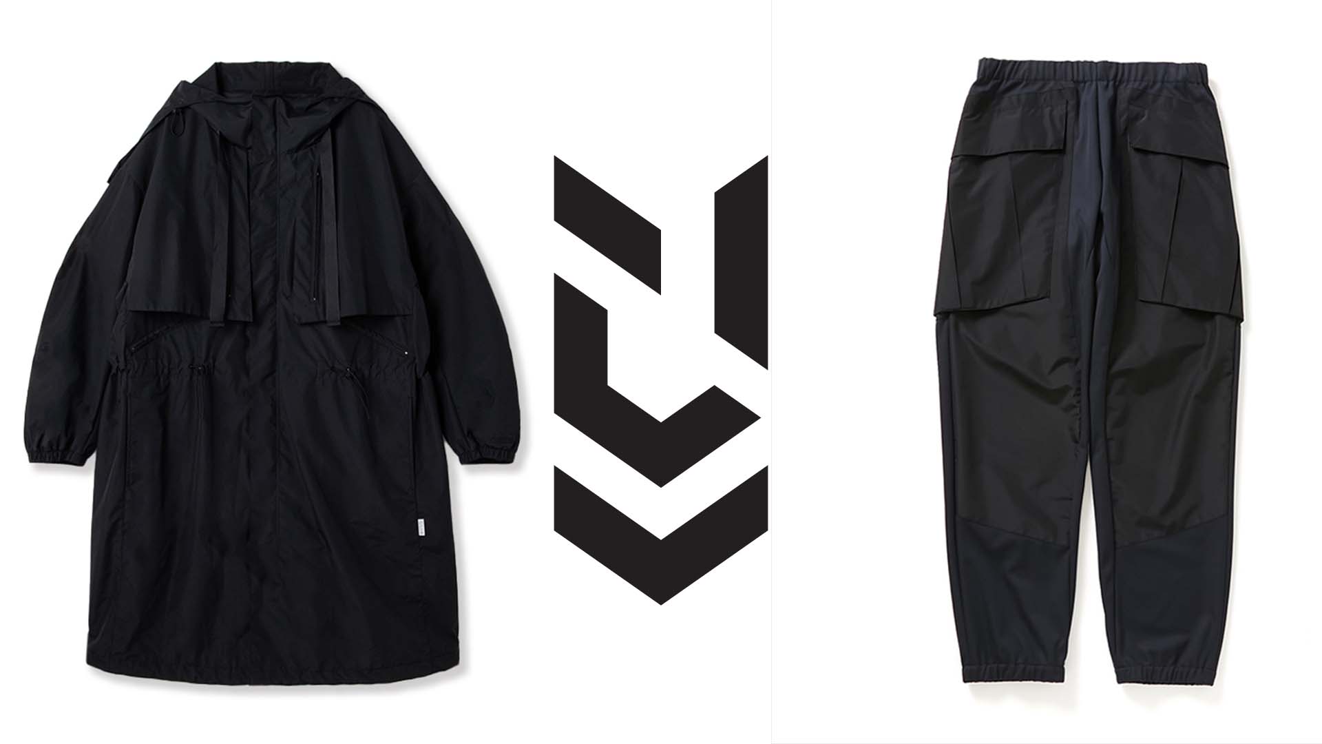 Flat product shot of a black hooded technical parka with adjustable drawcords and a pair of black cargo trousers beside a chevron brand logo